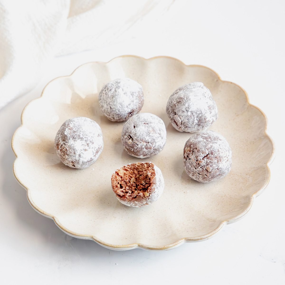 Close Up Shot For Taste Of Home Rum Balls, With A Bite Out Of One Rum Ball.