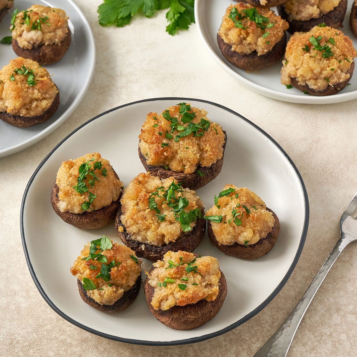 A square of Stuffed Mushrooms with Crabmeat, showcasing the rich crabmeat filling and golden baked exterior, by Taste of Home.