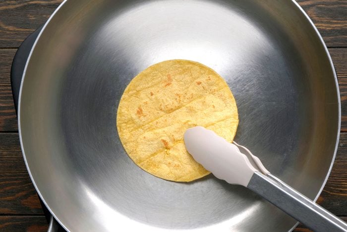 Toasting a tortilla in a dry large skillet